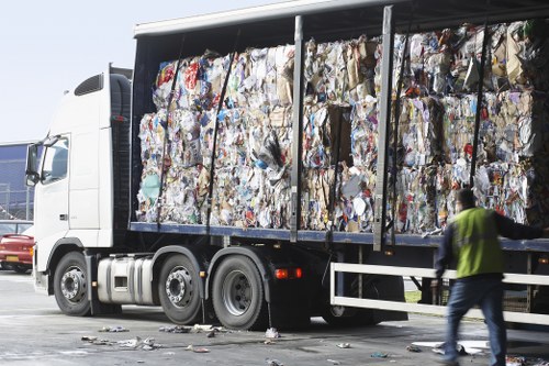Workers sorting mixed recyclables at a transfer station